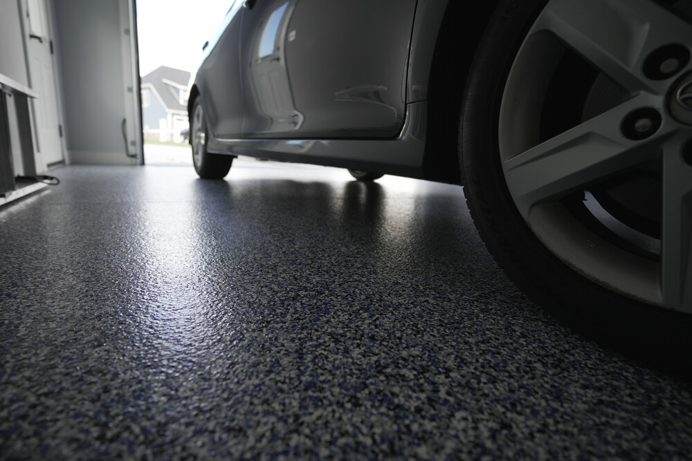 up close view of garage floor coating with white car